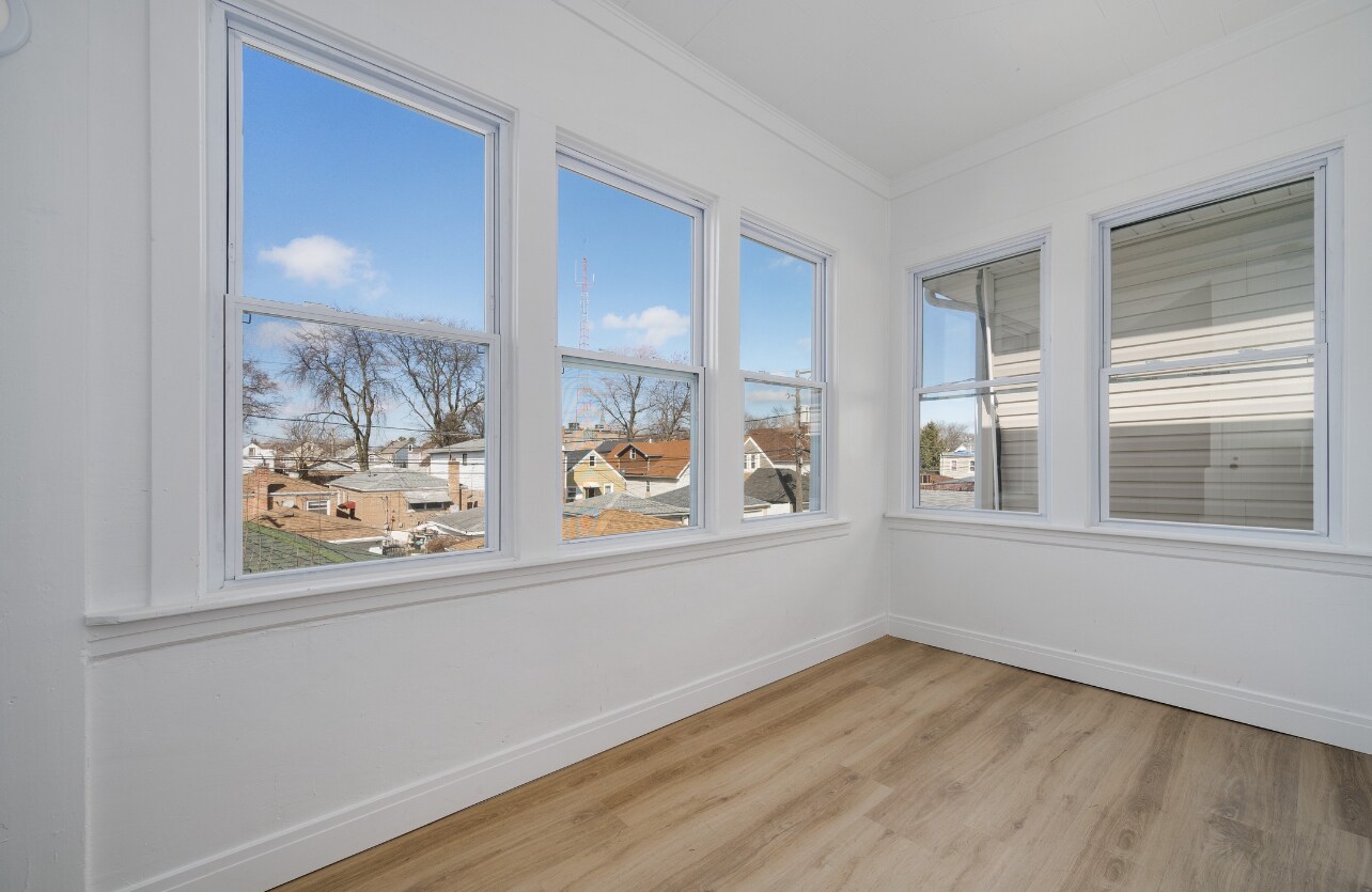 Cozy porch with abundant sunlight for plants. - 2836 W 40th St