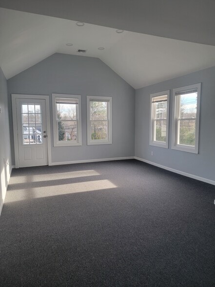 Large living room with vaulted ceiling and lots of sunlight - 12 Ridge Ave
