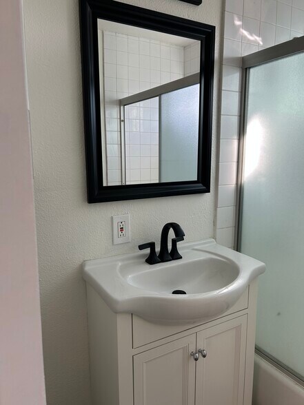 Freshly painted bathroom worh new sink, faucet, light fixtures, and mirror - 225 E Fremont Sq