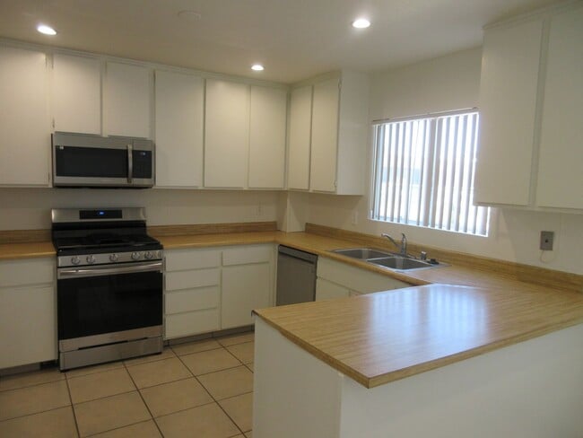 Building Photo - Duggan Property Management, Inc presents  *Reduced*  Canoga Park- 3BD 2.5BA