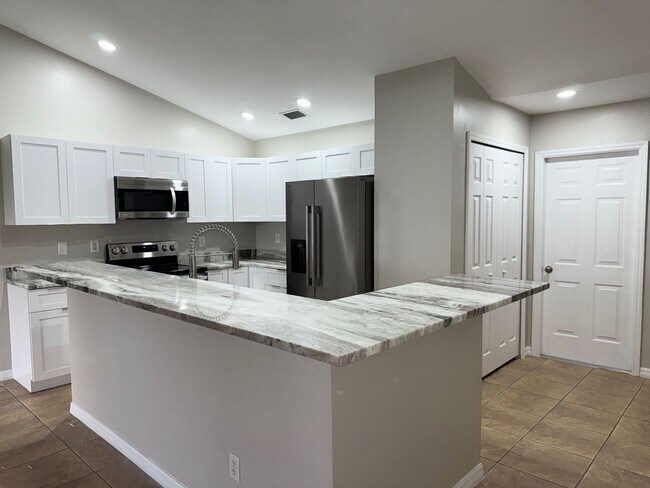 Building Photo - Experience this Cape Coral 3 bedroom 2 bath corner duplex with 1 car garage and screened in lanai.