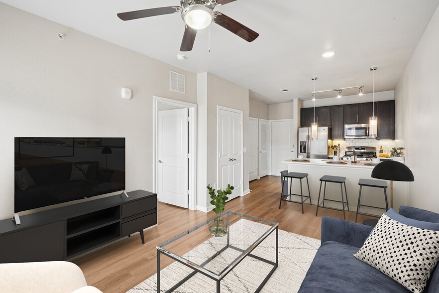 Kitchen and living room with hard surface flooring - Avalon Wolf Ranch