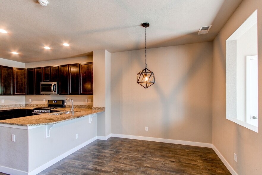 Dining room with bar height overhang countertop - 1745 W 66th Ave