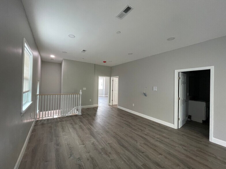 Unit two: open-concept living/dining space with view (left to right) of: staircase entry, master bed - 34 Falcon St