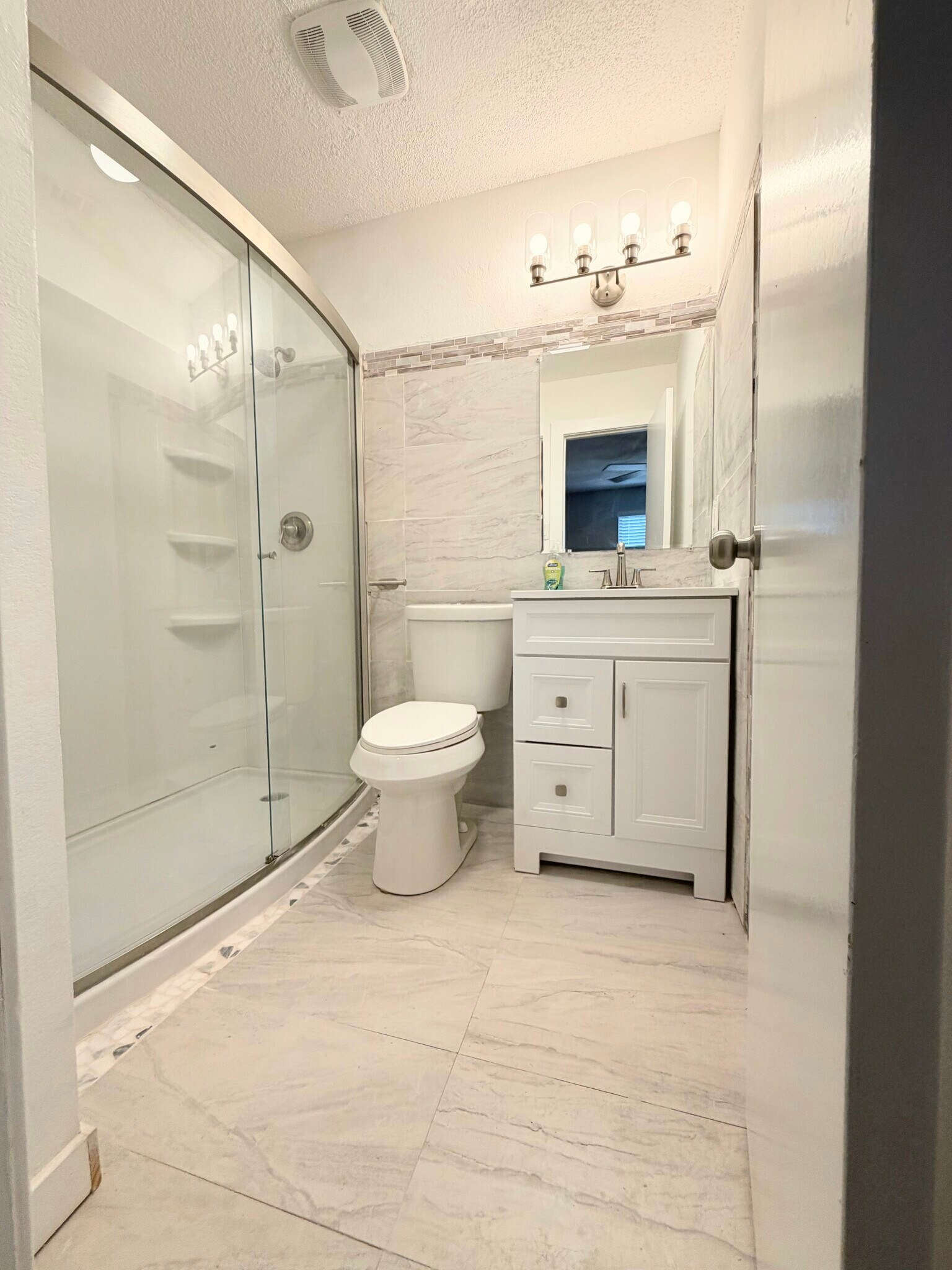 Master bathroom with Walk in shower and beautifully stoned tile accents - 7501 April Ln