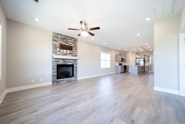 Building Photo - Elegant Home with Stone Fireplace, Kitchen Island and Designer Primary Suite