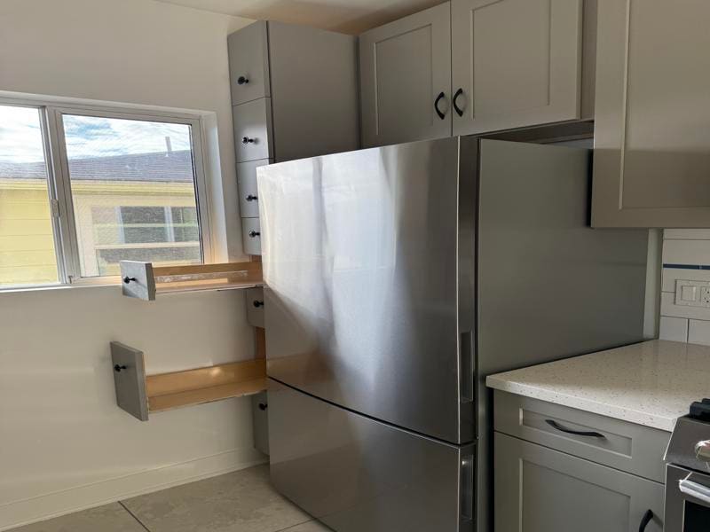 Custom slide out pantry drawers next to fridge - 1533 Princeton St