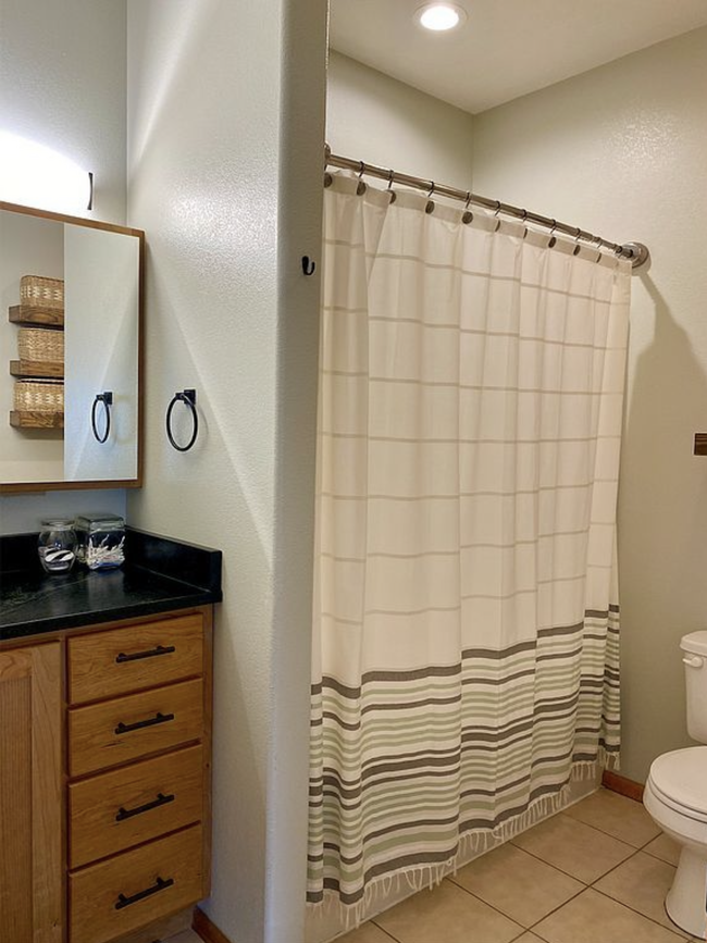 Main level bath with stone countertop and luxury fixtures. - 711 S 11th St