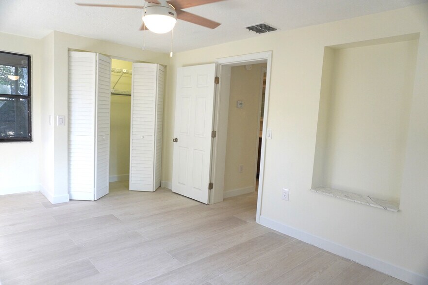 Cozy primary bedroom with ample closet and fan—ideal for restful nights in tranquil Yankeetown. - 33 63rd St