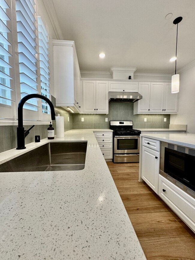 Building Photo - Beautifully Remodel Townhouse with AC & Two Car Garage!