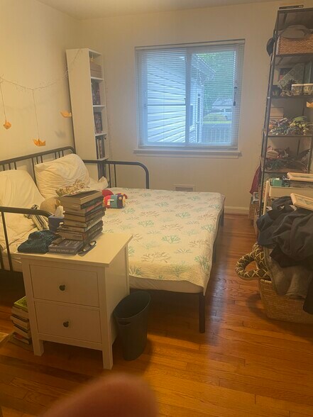 Bedroom 2 has wood floors and view of deck and yard. - 9707 Bristol Ave
