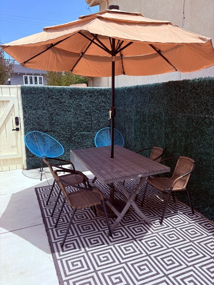 Outdoor dining table and chairs with umbrella - 206 W Maple Ave