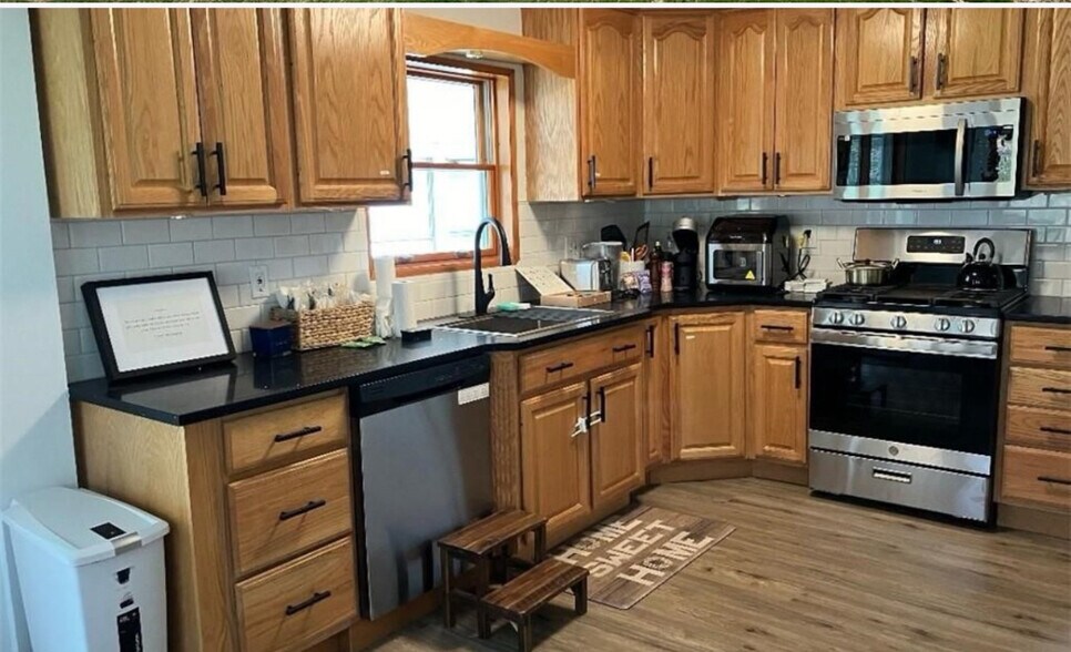 Newly renovated kitchen with granite countertops and all new appliances. - 22 Holt Rd
