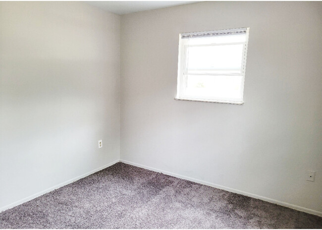 Step into this cozy bedroom, a perfect blank canvas ready to become your personal retreat. - Beecher Street