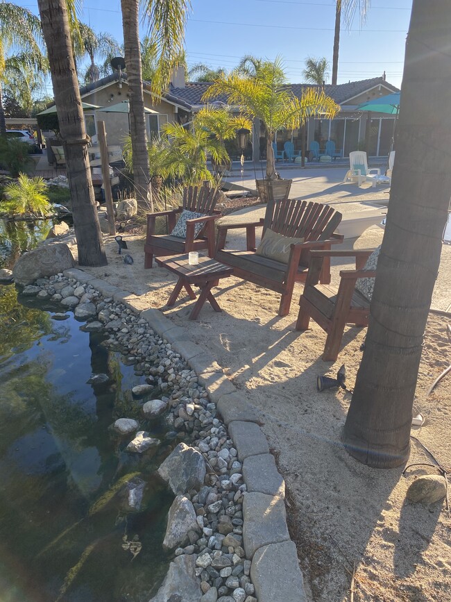 Seating area by large pond - 1305 E San Bernardino Ave