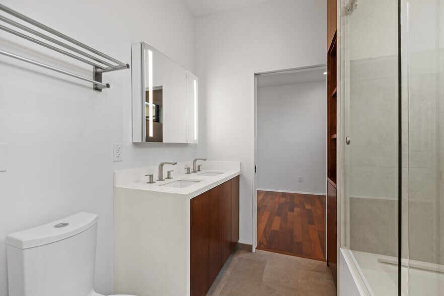 Bathroom with clean lines and lighted mirrors. - 4640 Del Monte Ave