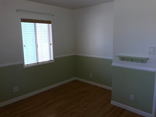 Second bedroom at front of house has original oak flooring, and bonus space where closet was removed - 14911 Fonthill Ave