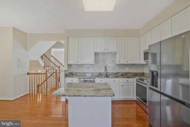 Building Photo - This beautifully maintained brick-front, three-level townhome is located in a highly sought-after...