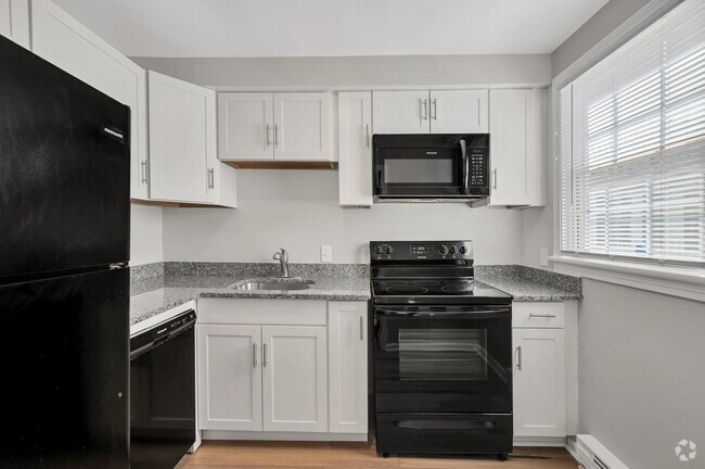 Stunning new renovations include sleek black appliances, and white shaker cabinets. - Linden at Highland Park