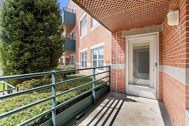 Building Photo - Updated 1BR Condo with Balcony, Garage Parking & Storage Near Commuter Rail