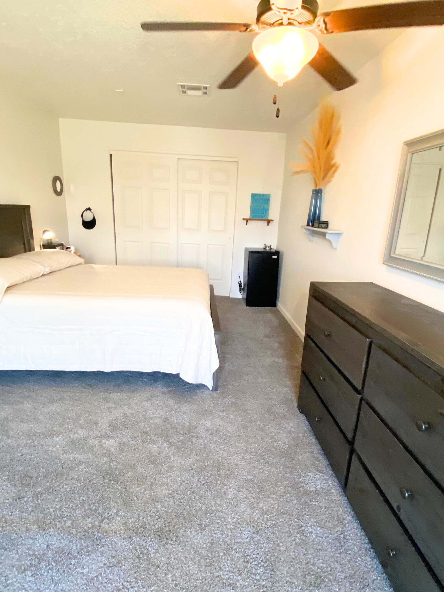 Room 4: - Spacious room - Equipped with bed, dresser, nightstand, and lamp, personal safe - 8941 E 24th Ln