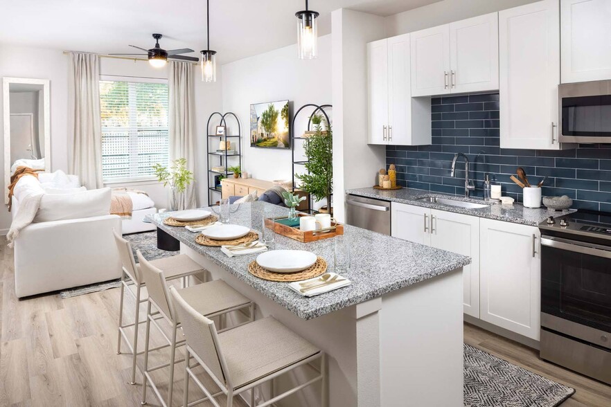 Experience seamless living with open-concept designs, merging kitchen and living spaces. - Windsor West Plano