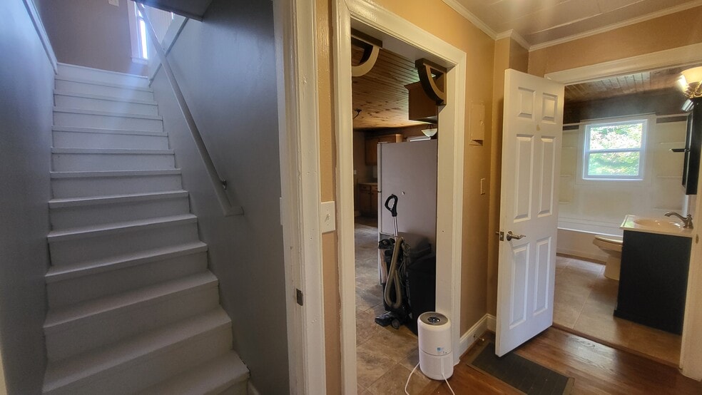 halway looking into kitchen, bathroom and to upstairs. Behind you is living room bedroom #1 - 116 Faw Rowland St