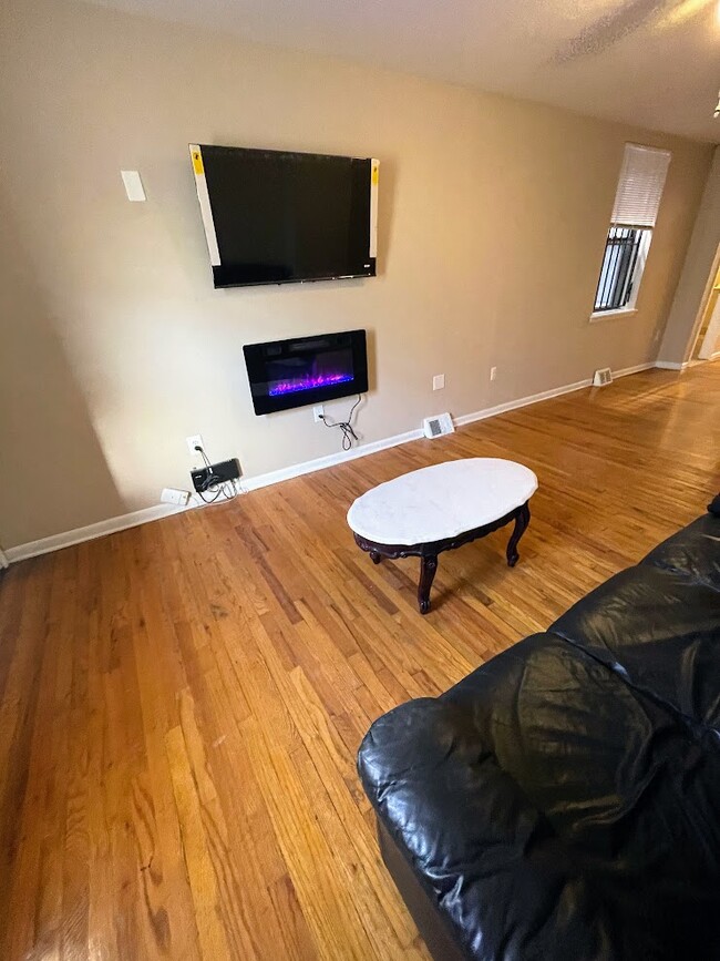 Apt 1 - Living Room w/ Fireplace and TV - 2148 N Carlisle St