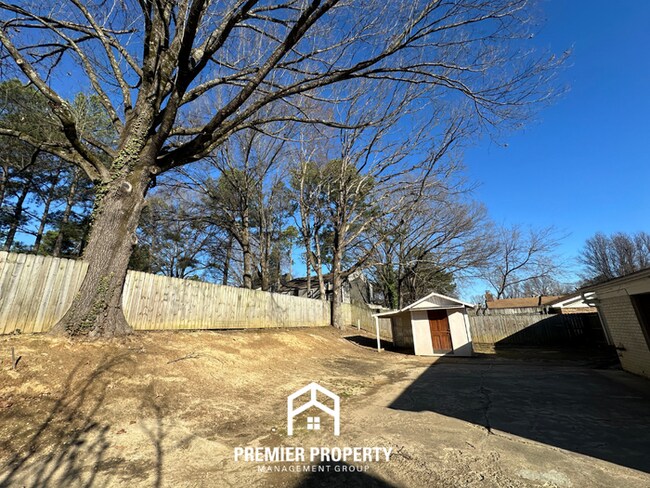 Building Photo - Charming 3BR Memphis Home | Rustic Brick Fireplace, Formal Dining & Fenced Backyard