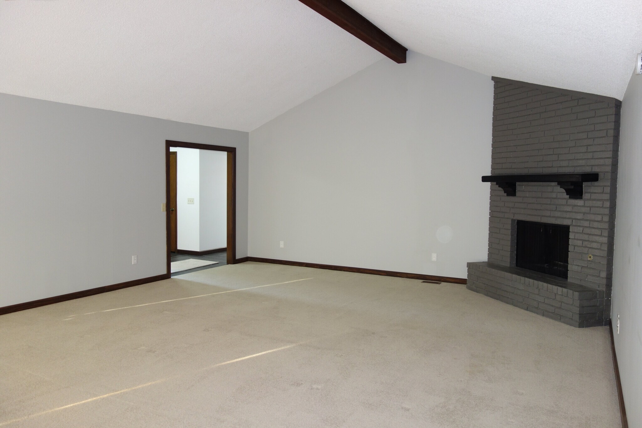 Living room with view of fireplace and entry access on left - 3324 E 73rd St