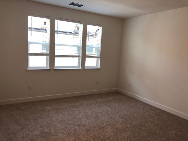 Building Photo - Tri-level Townhome with 2 Car Attached Gar...