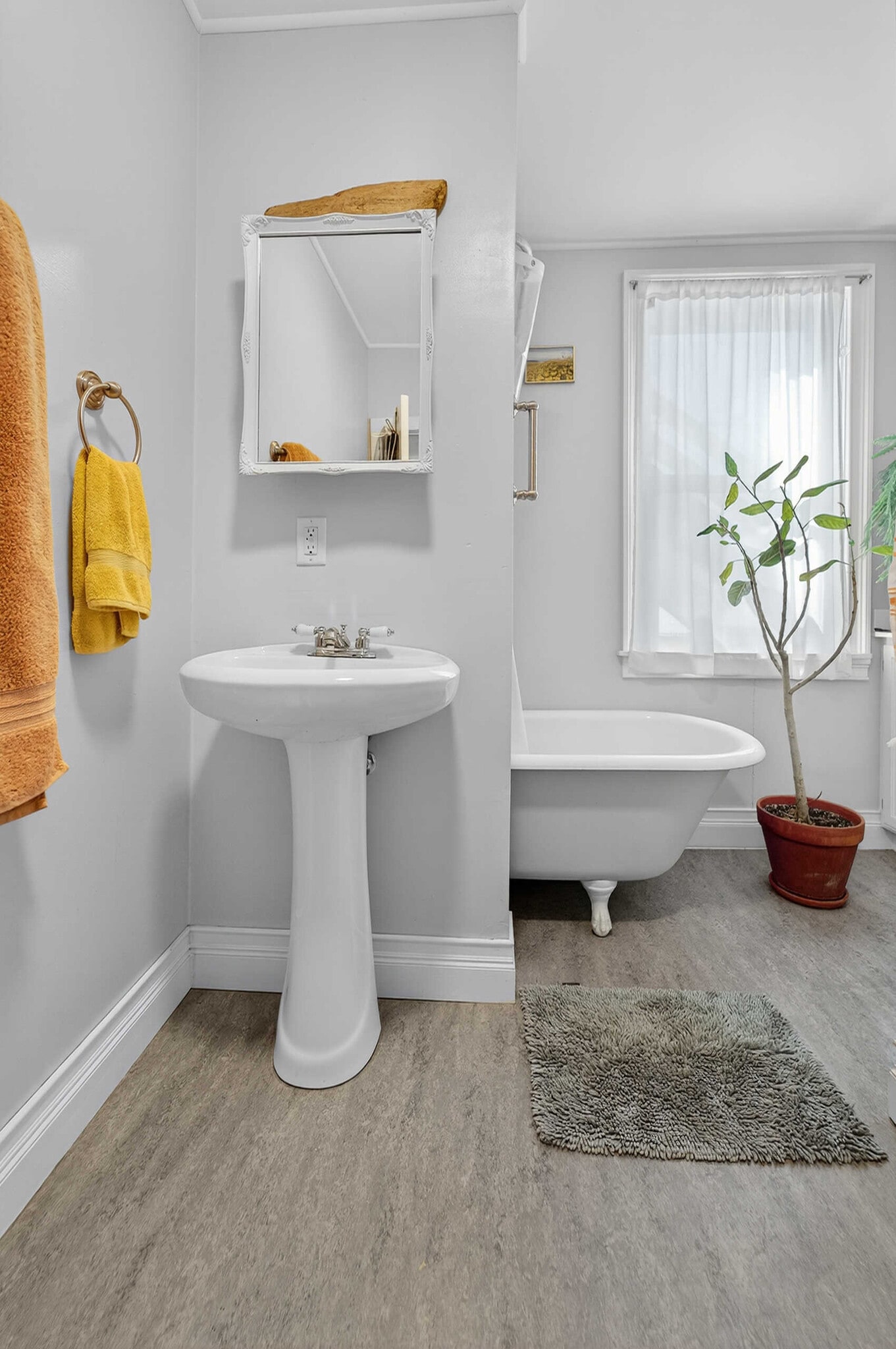 Bathroom features that lovely and deep claw foot bathtub. - 302 Van Deusen St
