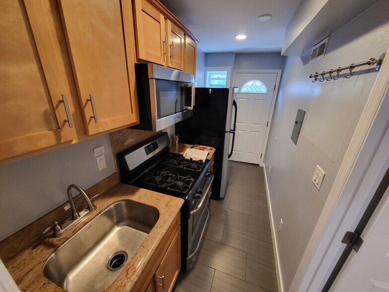 Kitchen sink with disposal, gas stove and stainless steel refrigerator - 2206 Lincoln Ave