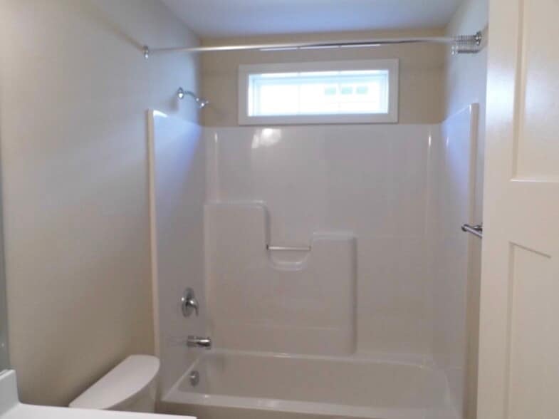 Full bath has shower/tub combo, built-in shower curtain rod, transom for natural light - 2312-A Belle Ave NE