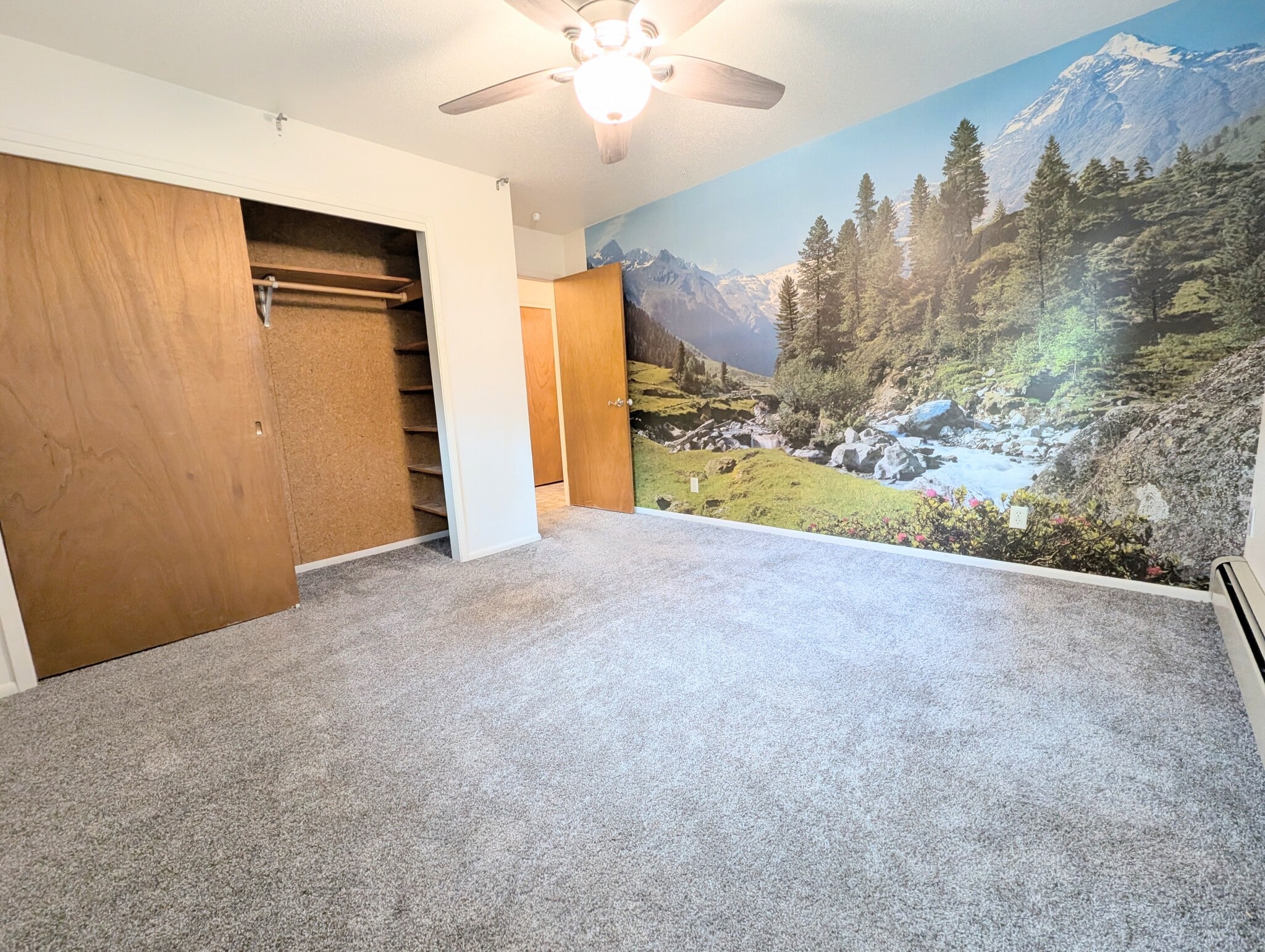 bedroom 2 has built in shelved in the closet and large mountain mural - 2575 Yew Street Rd