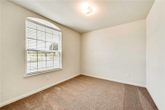 Building Photo - This lovely 4 bedroom home features a large family room with lots of light.