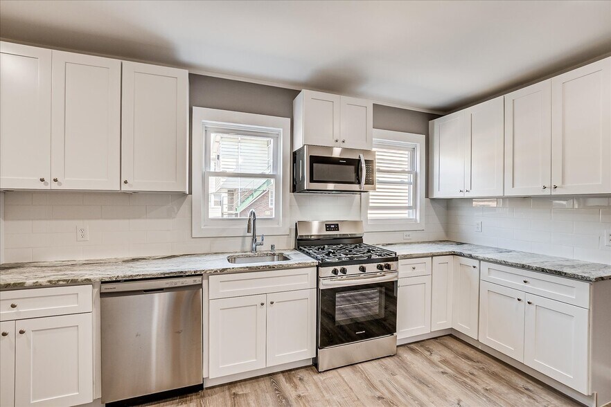 Kitchen view 4 , lots counter space, granite countertops, tile backsplash - 128 Berwick St