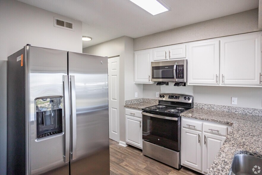 Kitchen with granite counters, modern cabinetry, and stainless steel appliances - Marina Pointe