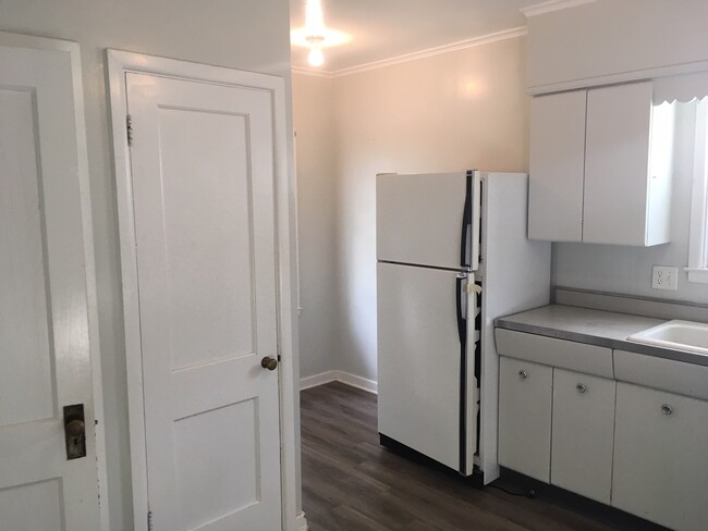 A view in the kitchen looking toward the eating area and pantry closet. - 1729 7th Ave S