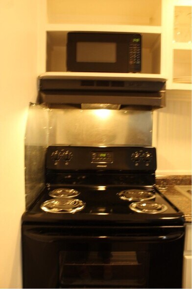 The kitchen includes a full size range and microwave. - 3813 Gallatin Pike