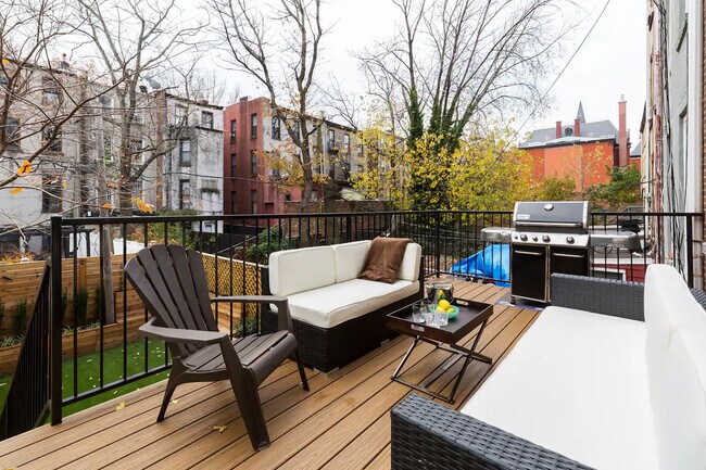 Rear deck off of the kitchen, with stairs down to garden - 140 Halsey St