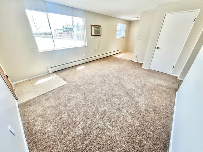 Experience the warmth and comfort of your new living room, filled with natural light. - Westland Apartments