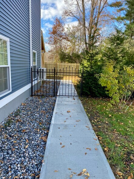 Walkway to gated private small grassy backyard. - 22 Denmore Ln