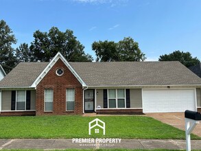 Building Photo - Spacious 4BR/2BA Near Southwind | High Ceilings, Brick Fireplace & 2-Car Garage