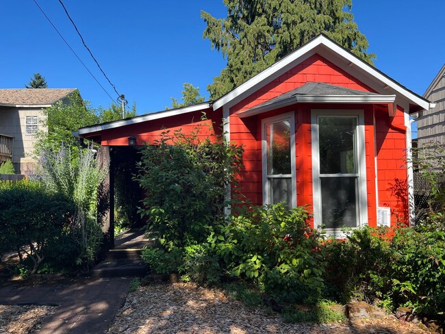 Building Photo - Charming Red Cottage with Lush Garden Spac...