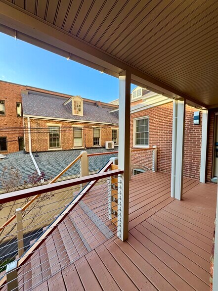 Enjoy the outdoors with a partially covered outdoor deck space! Spanish cedar drink rail and modern - 136 E King St