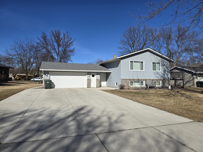 Front of the house with attached garage extra large driveway and available street parking - 775 Madson Ave SW