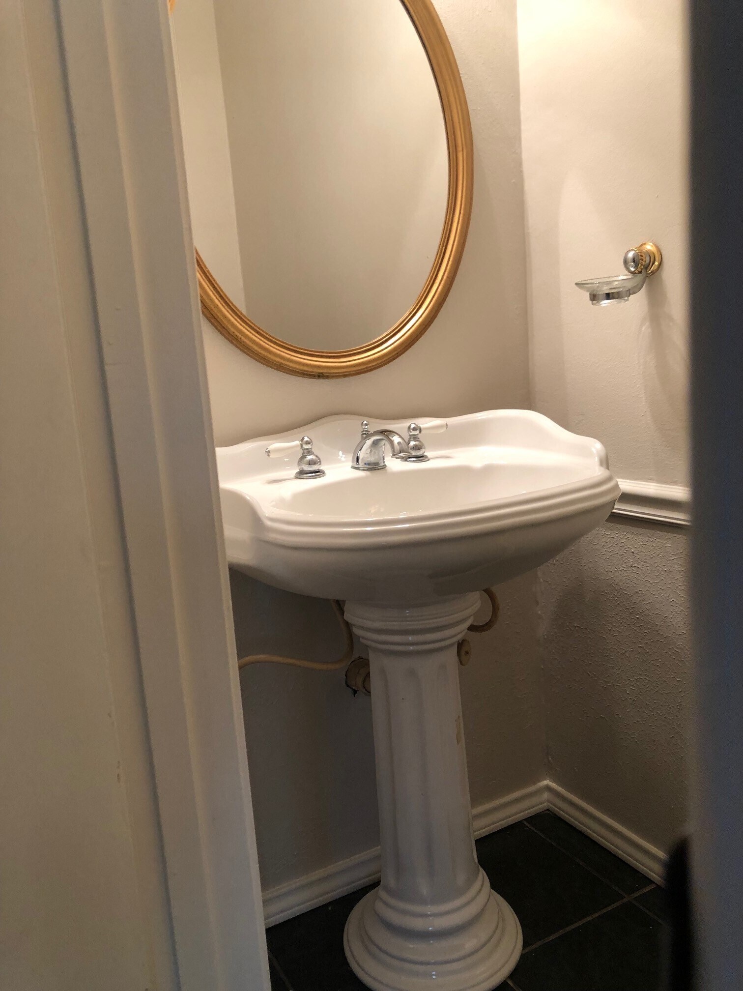 Downstairs half bath with large luxurious pedestal sink - 10019 Golden Sunshine Dr
