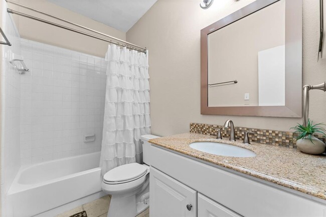 Spacious bathroom with shower/tub combo and granite countertop - 3500 Tangle Brush Dr