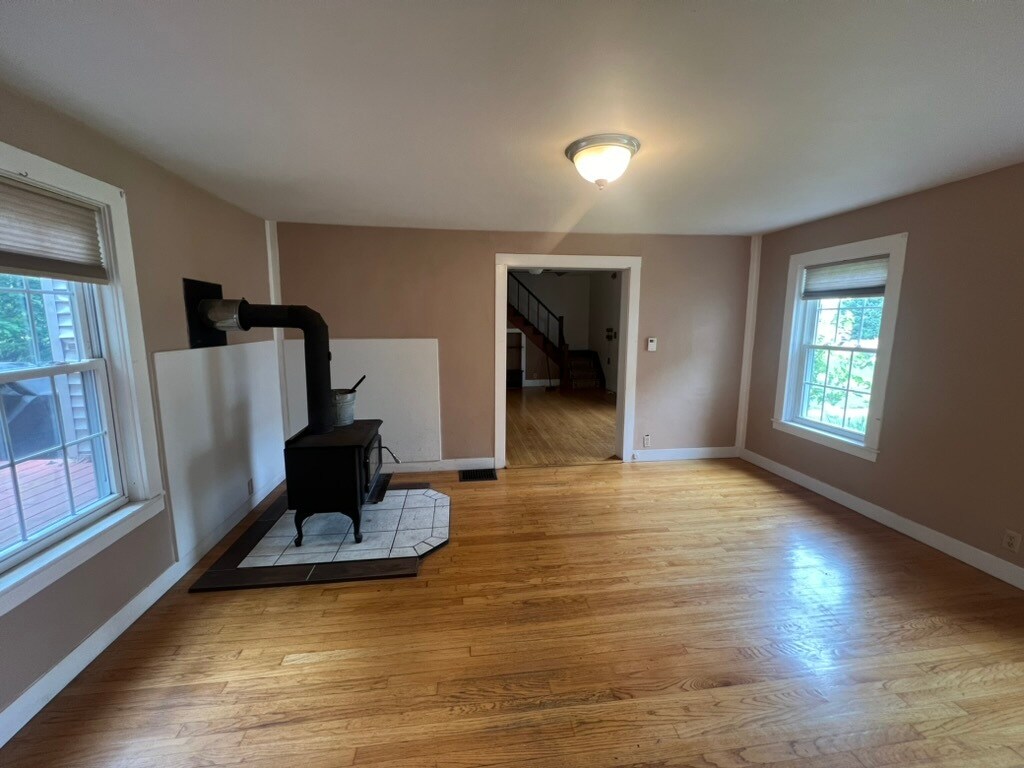 living room/dining room with wood stove - 104 Main St
